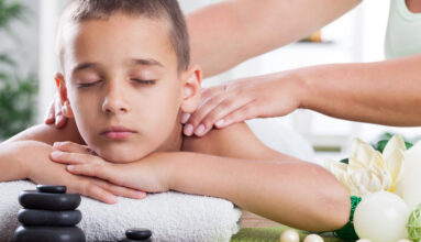 young boy  relaxing in spa. stone massage.