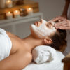 Young beautiful brunette girl in mask for face relaxing in spa salon. Eyes closed. Copy space.
